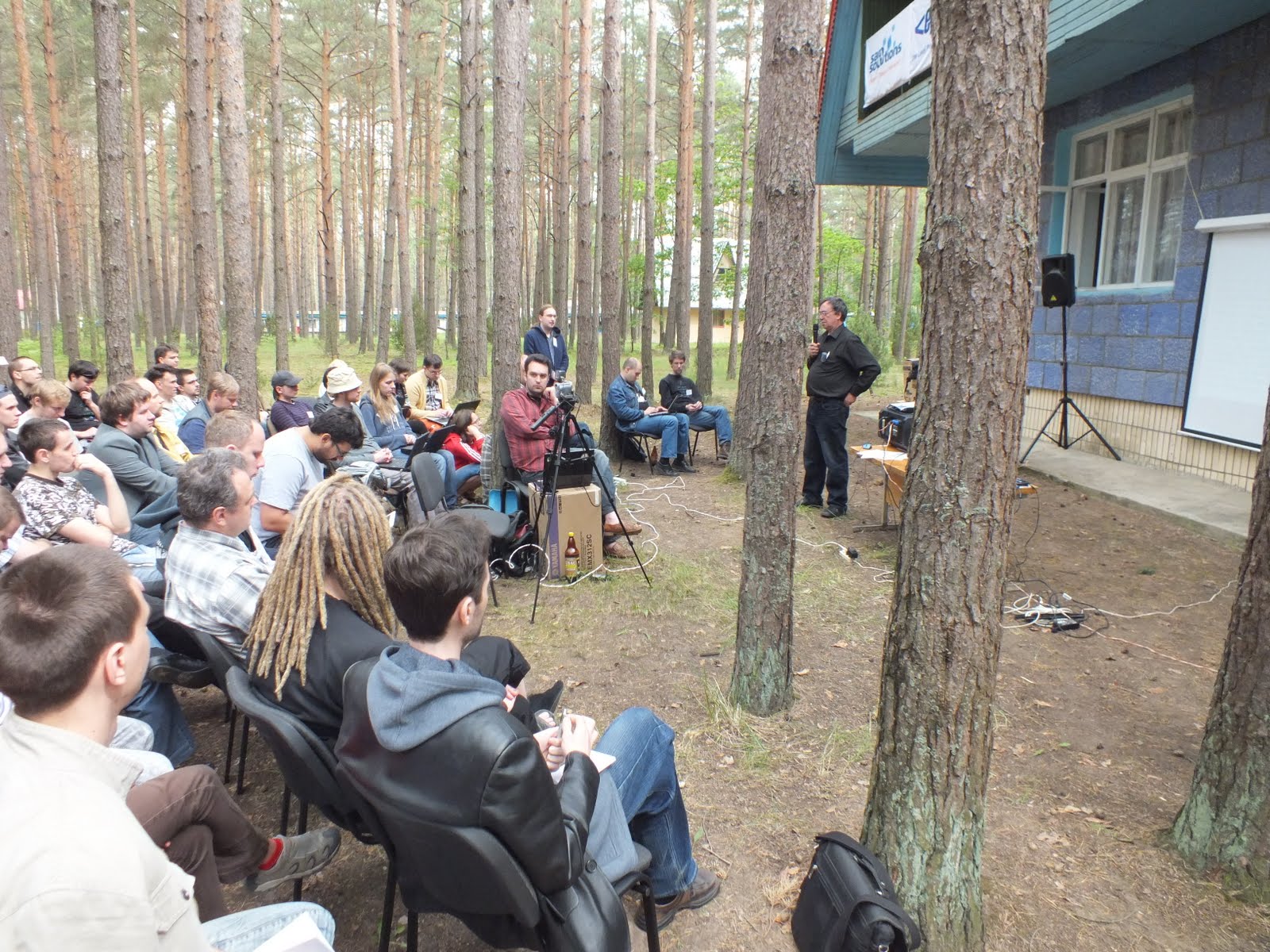 Grigory Zlobin in front of a house talks about FOSS in education in Ukraine